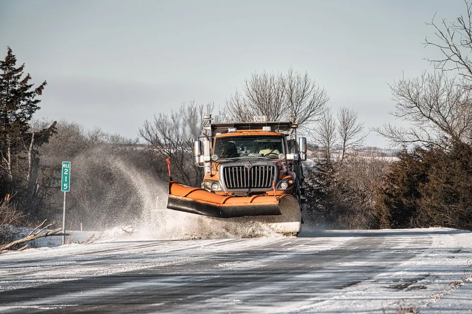A snowplow clears a snowy road in Wabasha, MN during winter.